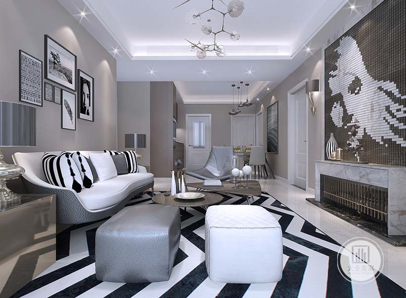 沙发墙面铺贴浅色壁纸，墙面采用黑白色装饰画装饰，沙发采用灰白搭配的真皮沙发，地面贴白色瓷砖搭配黑白条纹地毯。